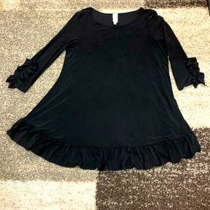 Come N See brand black tunic top with ruffle detail.